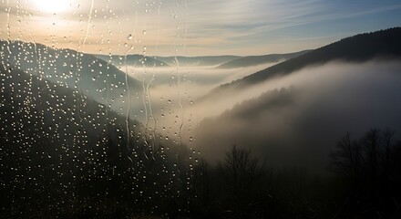 Misty Mountain Valley Sunrise with Fog and Sunlight over Lush Green Hills.