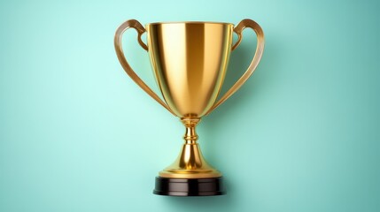 Fototapeta premium A shiny gold trophy with elegant handles and a black base stands against a teal background, symbolizing achievement and recognition.