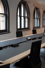 Modern open plan office arched windows empty desks natural light