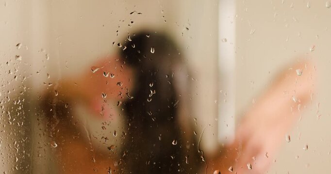 Girl in a shower with water drops, enjoying a refreshing moment in a cozy bathroom setting, captured in a serene and intimate atmosphere