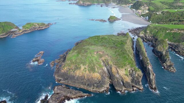Chiloe Island, Chile: Forward aerial drone footage of the dramatic coastline near Pu&ntilde;ihuil beach of Ancud in Chiloe island, Lake District of Chile on sunny day