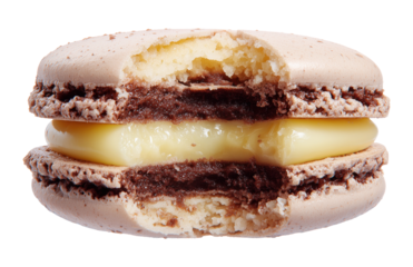 Brown chocolate macaron with cream filling shown from side angle with bite mark, isolated on transparent background