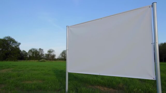 Blank white billboards in a lush green field under a clear blue sky perfect mockup 60 seconds