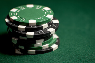 A stack of poker chips on a green felt table ready for a friendly game.