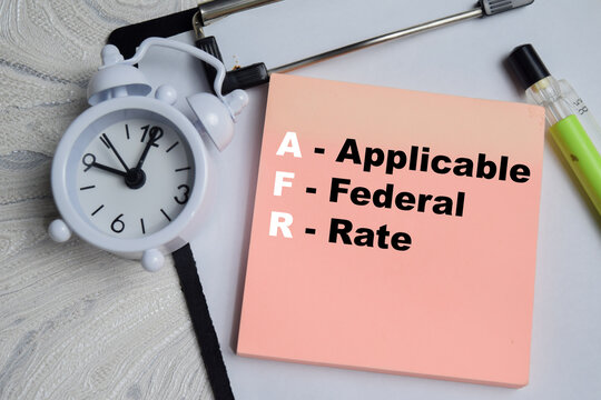 Concept of AFR - Applicable Federal Rate write on sticky notes isolated on Wooden Table.