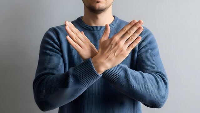Man crossing arms in X shape, gesture of prohibition or stopping