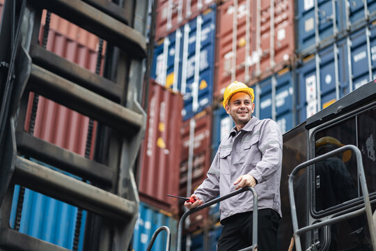 Caucasian logistic worker on reach stacker vehicle