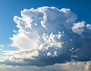 Large, fluffy cloud formation in a vibrant blue sky with sunlight