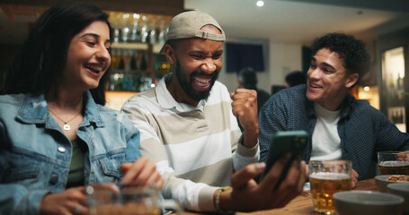 Winning, friends and fist pump with phone in pub for streaming match, sports goal and team support. Football fans, people or smartphone with celebration in bar for game score, live broadcast or event