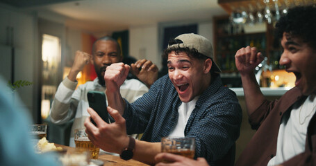 Phone, celebration and men in pub for sports game with goal, victory or winning championship. Happy, cellphone and group of male friends with cheering for watching football match in bar together.