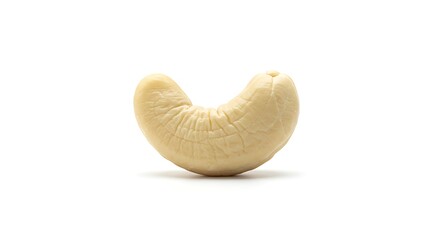 Close up shot of a single raw cashew nut against a clean white backdrop
