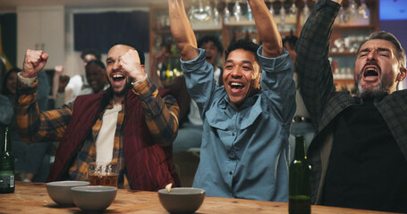 Happy people, winning and watching tv with fist pump for sport victory, support or success in pub. Excited group, men or fans with celebration for goal, online entertainment or score in local bar