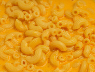 Macaroni and cheese soup in white plate