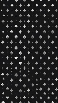 Dense pattern of playing card suits in grayscale against a dark background