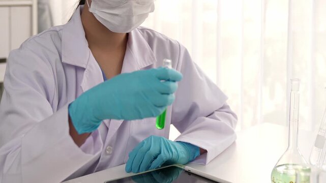 Laboratory researcher develop new medicine or cure use colorful chemical liquid in lab tube. Technological advance of healthcare with scientific or chemistry expertise and laboratory equipment. Rigid.