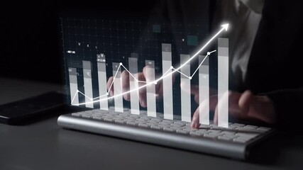 A close-up view of hands typing on a keyboard with a visually engaging financial graph overlay, symbolizing growth, analysis, and success in a digital workspace. Copula - Powered by Adobe