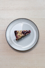 A plate with a slice of cherry cake.