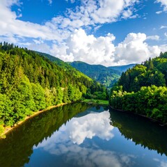 Fototapeta premium Scenic landscape featuring a river reflecting the cloudy sky
