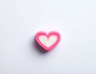 Obraz premium Pink and white heart-shaped confection on a plain white background