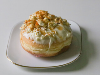 Donut with glaze toppings on white background