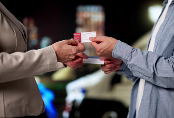 Drivers Calmly Exchanging Insurance Information After Car Accident At Night