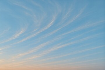 Pastel cirrus streaks across clear sky