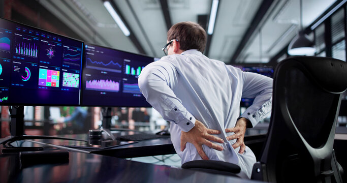 Man With Bad Posture Suffering From Back Pain