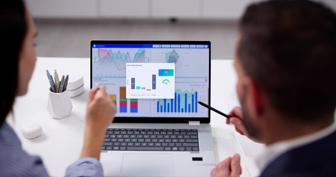 Young Data Analyst Analyzes KPI Dashboard On Computer