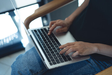 Close up of casual business woman hands typing on laptop computer, searching and surfing the internet, remote working, telecommuting, freelance at work concept