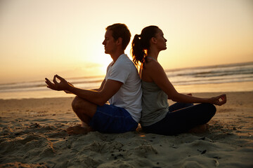 Beach, meditation and yoga with couple at sunset together for holistic health or support. Awareness, balance and wellness with yogi people outdoor for exercise, lotus pose or mindfulness routine
