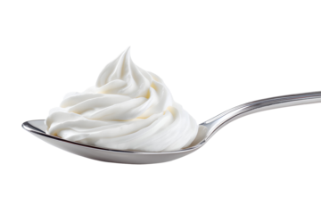 A silver spoon filled with a generous swirl of fluffy white whipped cream