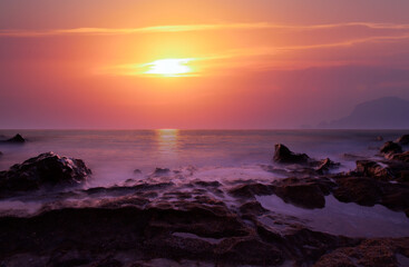 Long exposure photo of sunset on a rocky beach - Alanya, Turkey