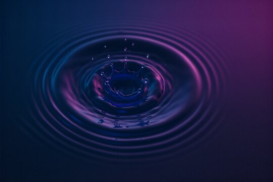Indigo water vortex swirling in luminous darkness