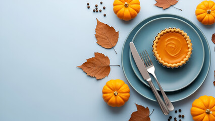 Autumn Thanksgiving Table Setting with Pumpkin Pie and Mini Pumpkins