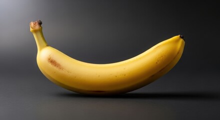 Vibrant Yellow Banana on Dark Background - A Fresh Fruit.