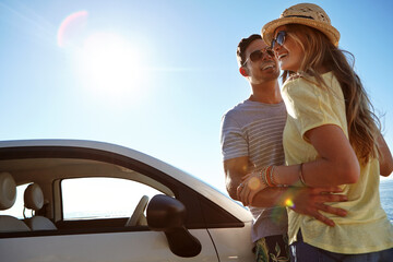 Couple, adventure and road trip with car, hug and laughing on summer holiday, low angle and outdoor. Happy, man and bonding with woman in nature, embrace and journey with vehicle, sunshine or space