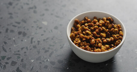 dried seaberry in white bowl on terrazzo countertop