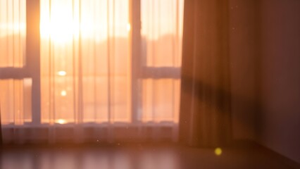 Warm sunlight streams through a window into an empty interior space