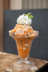 Shaved ice Bingsu with milk, Thai tea with whipped cream.