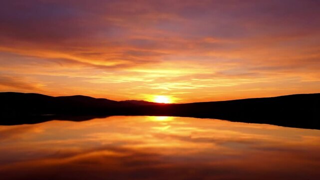Vibrant celestial display as the sun dips below the horizon, painting the clouds with an array of warm and evolving hues. Wide shot capturing the full breadth of the colorful sky.