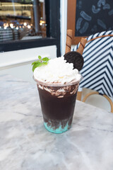 A delicious ice blended drink, topped with whipped cream, chocolate, and cookies. A perfect treat for any occasion.