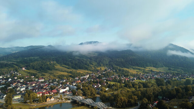 Aerial view observing the mountain village at sunrise fog - Powered by Adobe