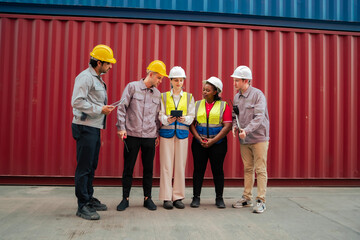 A diverse logistics team inspects shipping containers using a tablet to verify cargo data and coordinate transport. Accurate workflow, safety standards, and teamwork in modern supply chain operations.