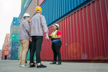 A logistics supervisor discusses cargo updates with warehouse staff at a container yard. The scene...