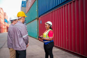 A female logistics officer leads a discussion with warehouse staff, ensuring accurate cargo tracking and smooth operations in a busy container terminal environment.