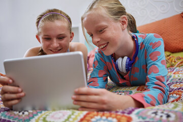 Home, teenager and girls with tablet, relax and bonding together with happiness, internet and funny. Friends, children and tech with social media, humor and notification for online chat and joke