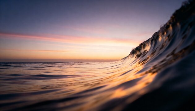 Golden wave crest at sunset ocean horizon with purple and pink sky abstract reflection