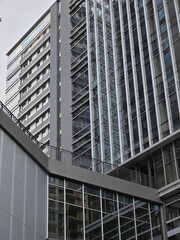 a vertical low-angle close-up view of modern office building exteriors in a corporate park of shenzhen, china