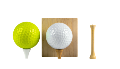 Three golf items a yellow ball on tee, white ball on wood, and a single tee
