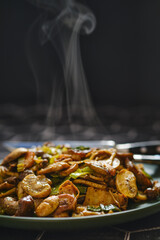 Sizzling stir-fried vegetables and mushrooms served on a plate with steam rising